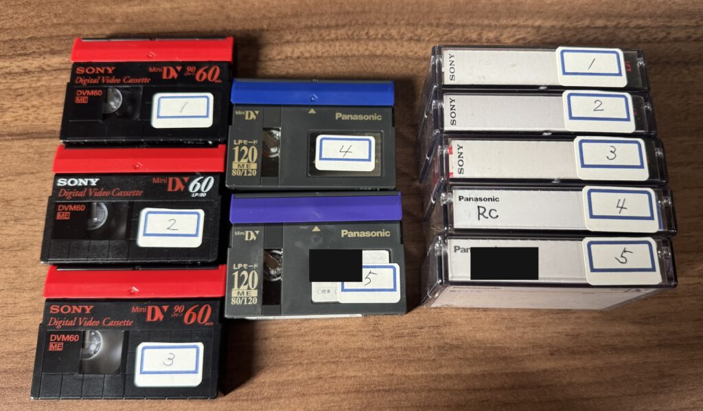 ケースから出したMiniDVのテープ5本に1から5の番号シールを貼り、ケース側にも同じ番号を付けた写真。名前の部分は黒く塗りつぶしてある